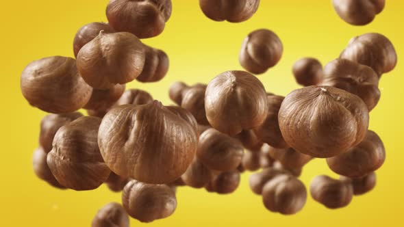 Flying of Hazelnuts in Yellow Background