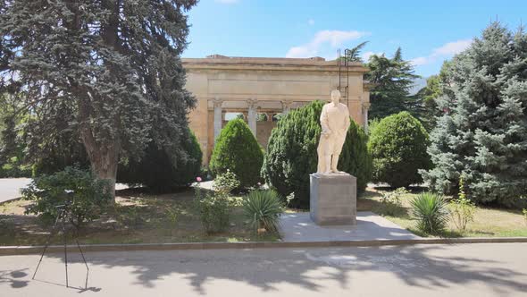 Flying over the Monument of Joseph Stalin in front of the Joseph Stalin Museum in city Gori, Georgia