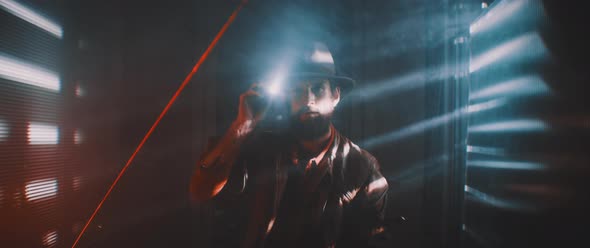 Man flashing flashlight towards camera in lights of shutters