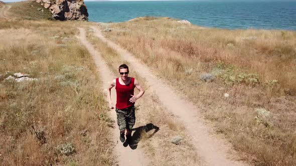 Aerial view. Man is running along general's beaches, Autumn in Crimea