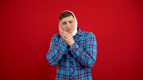 A Young Man Has a Rewound Head Due To a Pain in a Tooth