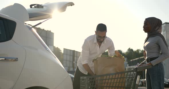 African Arabian Couple Pack Grocery in a Car