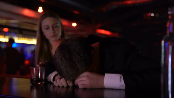 Young Woman Helping Drunk Man to Leave Bar, Holding Him, Alcohol Abuse Concept