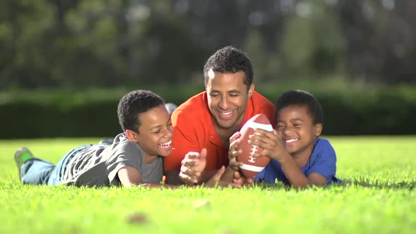 Group portrait of a father and his sons with a football