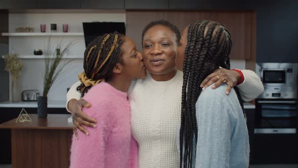 Cheerful African Mom and Daughters Posing at Home