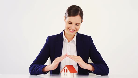 Businesswoman making home sign with a hand