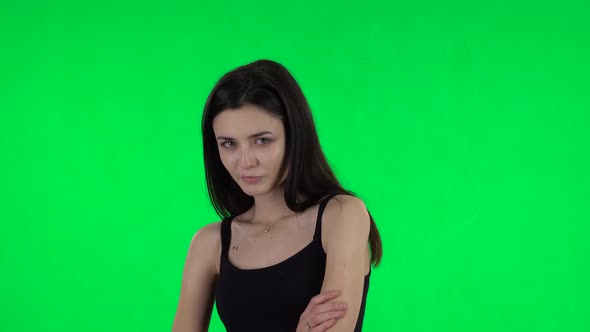 Young Female Stands Offended and Then Smiles. Green Screen