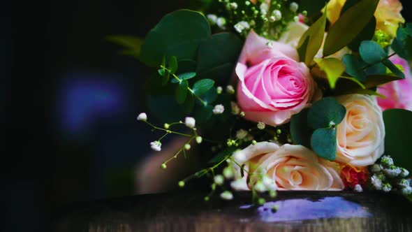 Bridal flower bouquet close up panning shot with dark background. Wedding day flower bouquet