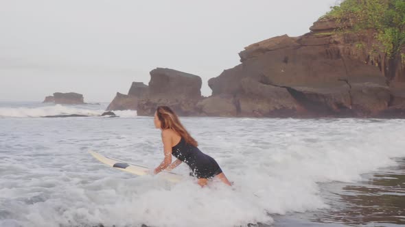 Woman Going To Catch Wave