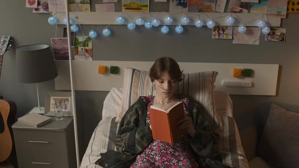 Young Adult Reading Book in Hospital