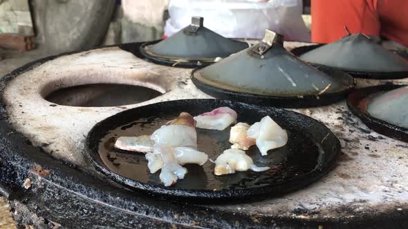 A Vietnamese woman is cooking crispy Vietnamese pancakes