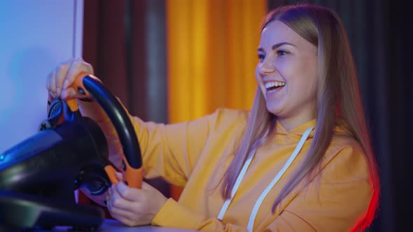 Girl playing with steering wheel, Young pro gamer girl playing car racing