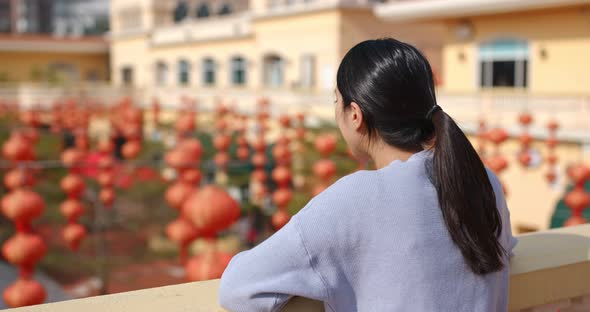 Woman look at the red lantern in the street