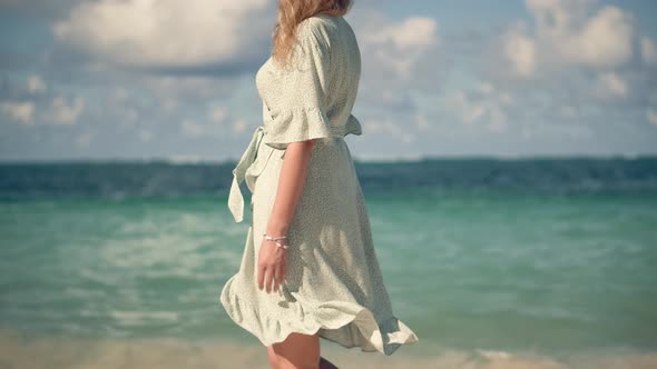 Flowing Dress Blowing In Wind.Travel Mood.Woman In Hat Walks Along Beach On Caribbean Holiday Resort