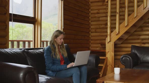 Caucasian woman spending time at home, working on a laptop