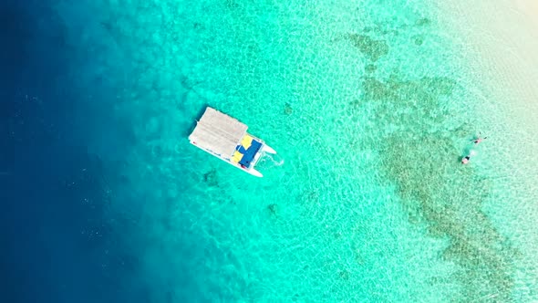 Aerial drone scenery of beautiful shore beach adventure by transparent sea with white sand backgroun