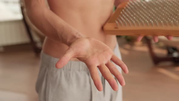 Man Touching Sadhu Nail Board With Palm