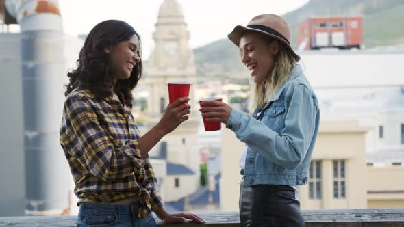 Young adult friends hanging out on a rooftop