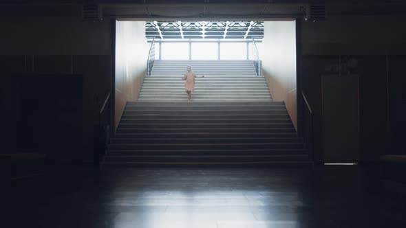 Little Girl Running Down Empty School Staircase Alone