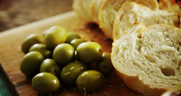 Green olives, oil, soy sauce and bread