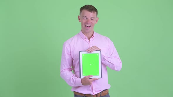 Happy Businessman Talking While Showing Digital Tablet