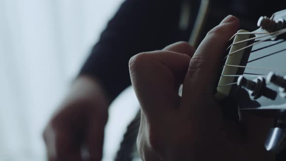 The musician plays the acoustic guitar