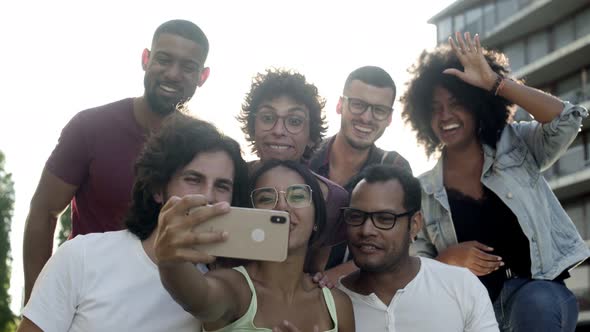 Smiling Young People Recording Video on Smartphone