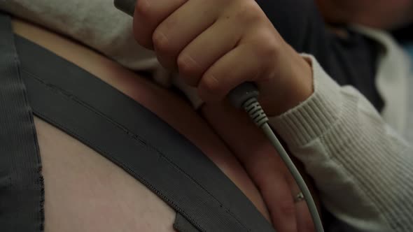 Close Up Pregnant Woman On Hospital Couch During Medical Control Cardiotocography