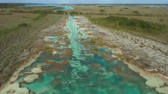 People Riding Kayak in Los Rapidos Lagoon in Bacalar Mexico