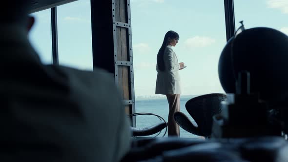 Businesswoman Watching Sea View Big Window