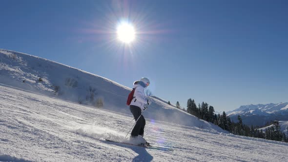 Skier Skiing Down On Ski Slopes On Skis On Sunny Winter Day Background Mountains