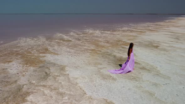 Woman in Flying Dress on Pink Salt Lake