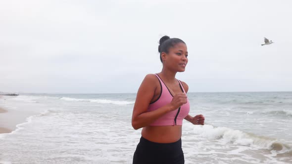 Mixed ethnicity woman working out at the beach