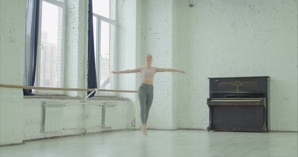 Ballet Dancer Performing Grand Jete in Dance Studio