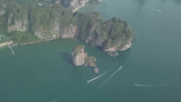 Aerial footage of Ao Nang beach, limestone rocks in sea, sailing boats, Krabi province, Thailand