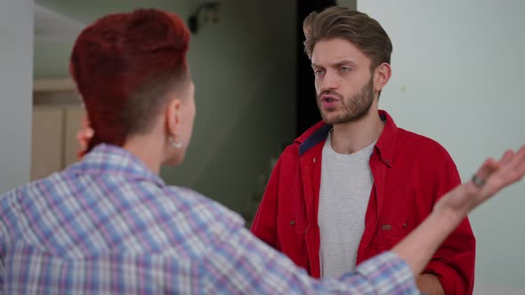 Dissatisfied Handsome Husband Arguing with Wife Doing Repair in New House