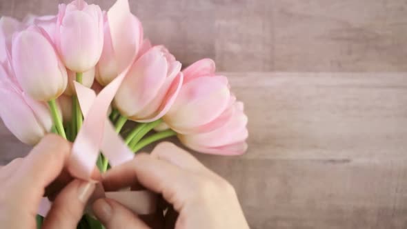Bouquet of pink tulips on a wood background