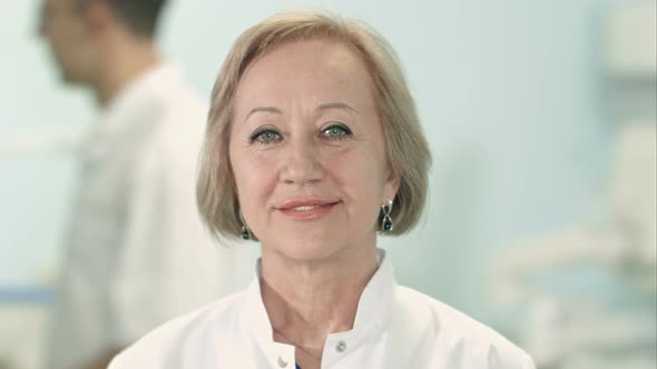 Smiling Senior Female Doctor Looking at Camera