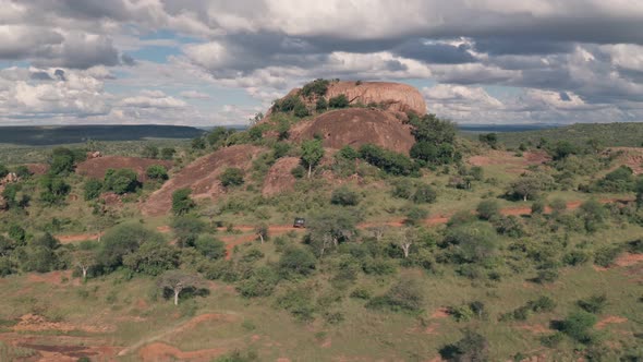 4 wheel drive adventure on wildlife safari holiday at Baboon Rock in Laikipia, Kenya. Aerial drone v