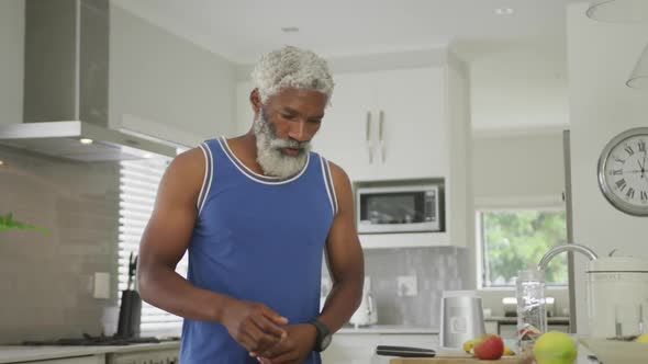 Video of african american senior man preparing smoothie