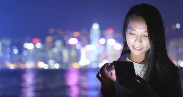 Business Woman Using Cellphone in Hong Kong City at Night