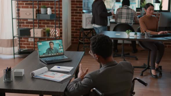 Person in Wheelchair Attending Business Meeting on Videocall