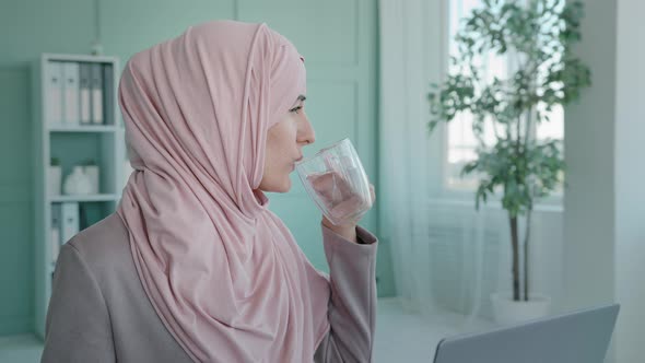 Islamic Muslim Businesswoman in Office Drinking Pill Female Entrepreneur Worker in Hijab Sitting at