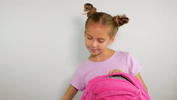 Smiling Girl Packing her School Bag. Preparing for School. Ready to Learn