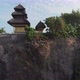 Aerial Flying Low Rising Up Vertically past cliff showing a temple and landscape in Bali - VideoHive Item for Sale