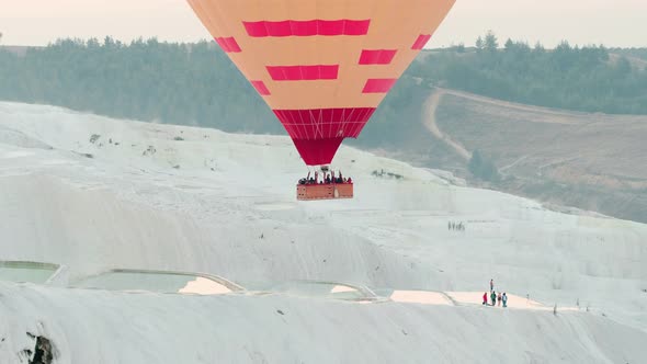 Hot Air Balloon Flying Over the Travertines in Pamukkale, Turkey