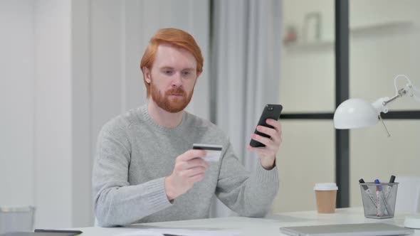 Successful Online Payment on Smartphone By Beard Redhead Man