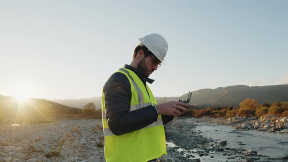 geologist with drone checks the territory