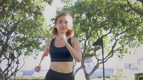 Young Woman Running in Park