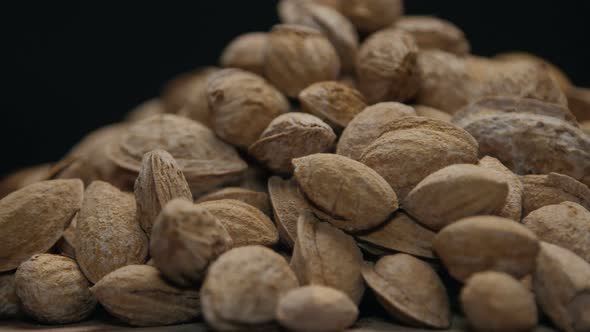 Pile Of Almonds In Shell On A Wooden Table